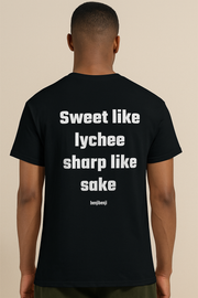 Back view of unisex heavy cotton tee featuring text 'Sweet like lychee sharp like sake' in bold design.
